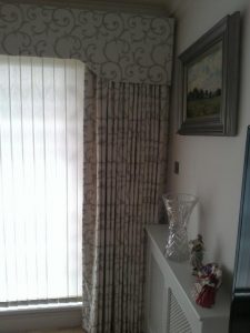 Shaped pelmet and drawn curtains